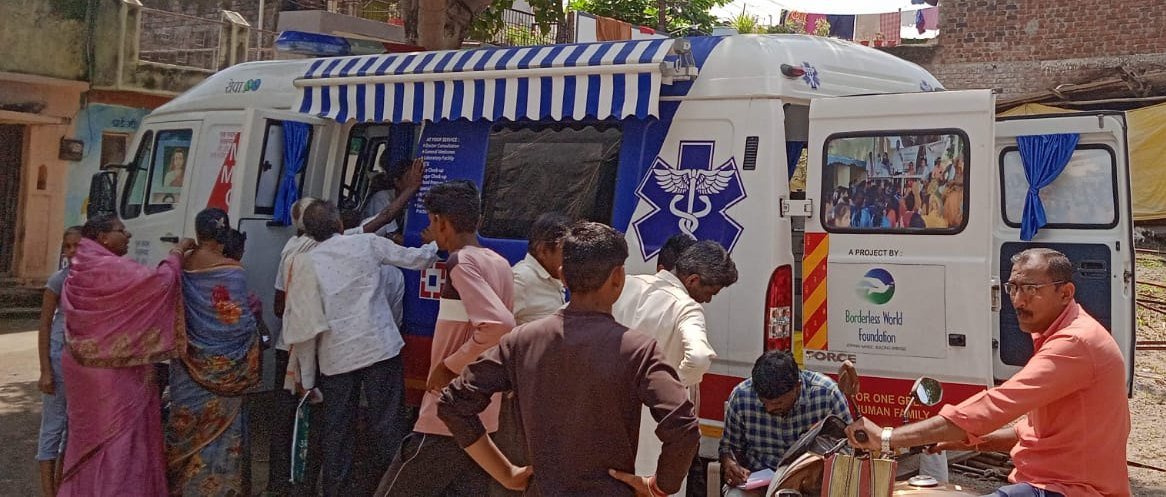 Mobile Medical Unit van with patients gathered around it